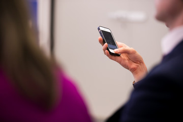 close up investor man hand gesture hold mobile phone device for reading or write digital content concept.