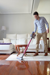 man vacuuming without wires.
