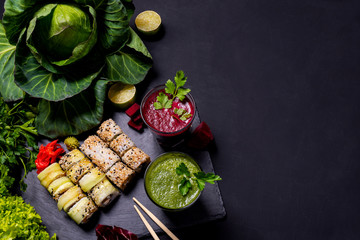 Japanese food. Healthy vegan drinks with fruits and vegetables on the black background. Flat lay