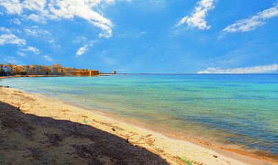 Trapani. Panoramic view of empty paradise turquoise beach near on waterfront and near city harbor, Sicily, Italy.