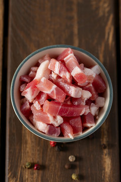 bacon cubes on wooden surface