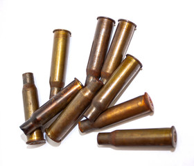 A pile bullet shells on a white background