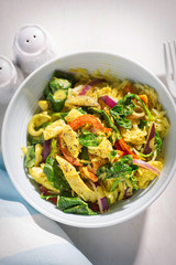 Green chicken curry. Chicken breast pieces in a coconut & cream sauce with cooked rice, spinach, red peppers & onion