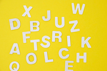  wooden letters on a colorful yellow background