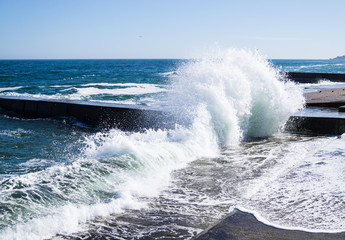 Sea waves on the beach, bright blue water