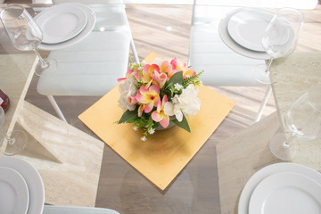 glass table setting with flower arrangement and fruit