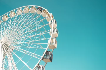 Deurstickers Big city ferris wheel on a background of clean blue sky © Iryna Burmii