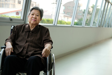 Fototapeta na wymiar elder woman in wheelchair resting near window. elderly female relaxing at home. senior leisure lifestyle
