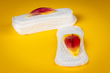 Daily panty liners on yellow background close-up. Discrete panty liner or pad for woman. Intimate hygiene. Woman hygiene protection. Women's health. Feminine pads. Critical days.