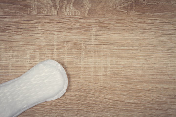 Daily panty liners on wooden background close-up. Discrete panty liner or pad for woman. Intimate hygiene. Woman hygiene protection. Women's health. Feminine pads. Critical days.  © sandis sveicers