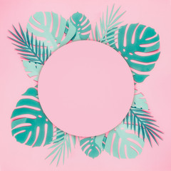 Various turquoise blue tropical leaves made with papercraft with round circle copy space for your...