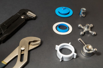 Plumbing work tools on a black background.