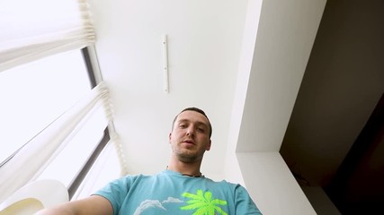 Man unboxing an electric toy car all-terrain vehicle out of the box on the background, the white interior of the apartment - Powered by Adobe