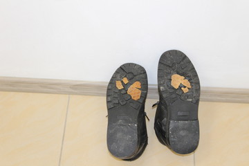 Old leather winter boot after repair rubber sole 