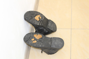 Old leather winter boot after minor repair of rubber sole 