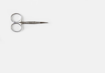 metallic silver manicure sharp scissors on a white background