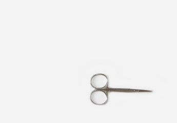 metallic silver manicure sharp scissors on a white background