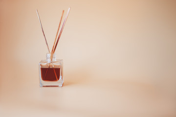 Air freshener sticks on begie background glass jar aroma bamboo sticks