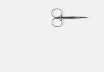 metallic silver manicure sharp scissors on a white background