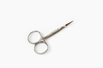 metallic silver manicure sharp scissors on a white background