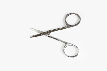 metallic silver manicure sharp scissors on a white background