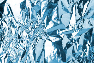 Crumpled light blue foil shining texture background, bright shiny cold icy design, metallic glitter surface, winter holidays decoration backdrop concept, metal shimmer effect, sparkling color pattern