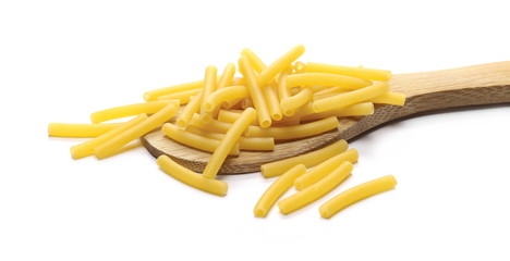 Macaroni, raw pasta with wooden spoon isolated on white background