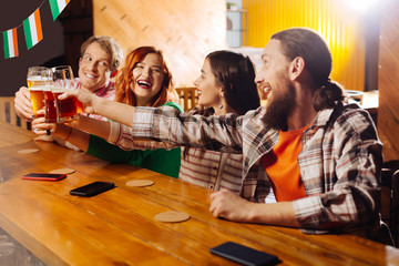 Company of two couples feeling amazing celebrating Friday together