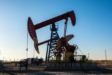 Oil pumps are running in the sunset at the oil field. On the Bohai coast of China.