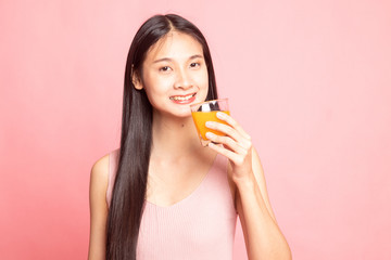 Young Asian woman drink orange juice.