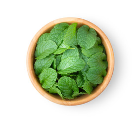 Fresh mint leaves pattern in wood bowl isolated on white background. top view