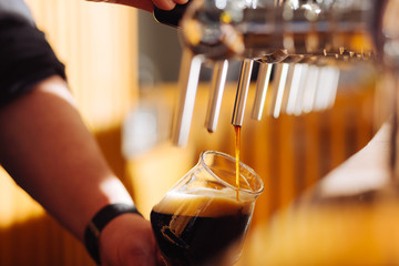 Close up of quality dark beer with foam in the glass