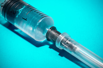 Medical Syringe on dark blue background.