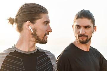 Two twin brothers doing exercises at the beach