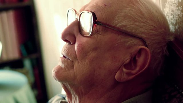 Senior man sleeping, resting on sofa at home, 4K