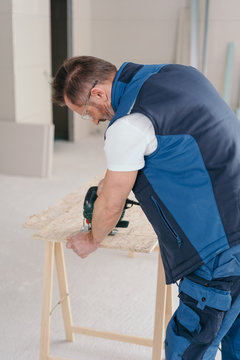 Handyman using a hand held electric drill