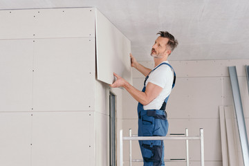 Builder or handyman fitting wall cladding