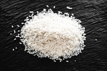 Risotto rice on the black background, overhead horizontal view