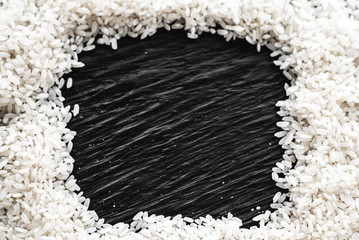 Risotto rice on the black background, overhead horizontal view