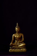 statue of buddha on dark background