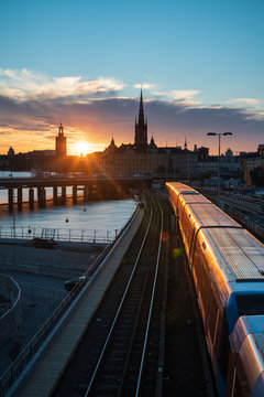 Sunset view of Gamla Stan and Stockholm metro train from Slussen