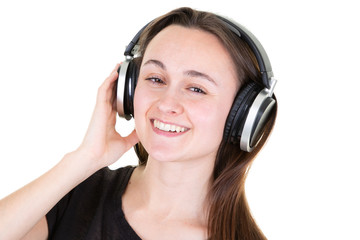 young woman laughing and listening to music with phone earphones