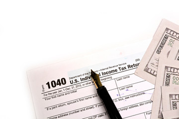 Completing US tax return form 1040 on white background