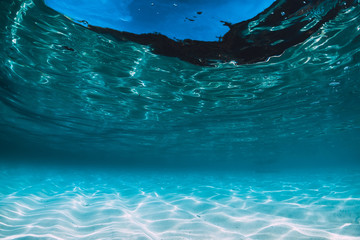 Tropical blue ocean with white sand underwater in Hawaii