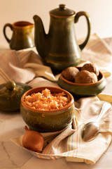 sauerkraut in a glossy cup with boiled potatoes in the peel