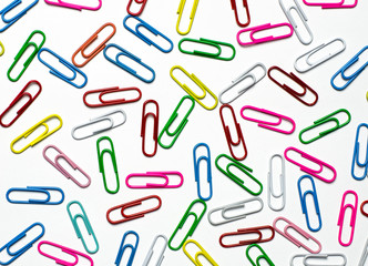 Colorful paper clips to documents lying on a white background