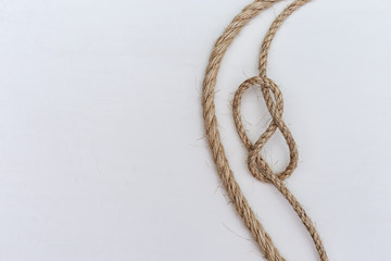 Figure-of-eight knot is type sea knot on white background. Copy space.