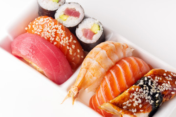 Creative layout with various sushi on white background. Shrimp, eel, salmon and tuna