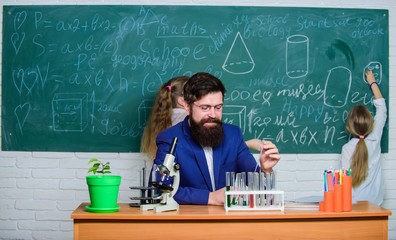 Research and training activities. Teacher and elementary school children in research laboratory. Science teacher and pupils doing research work. Experimental research is conducting a laboratory test