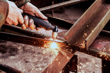 Cutting steel with plasma. Male welder cuts metal plasma.